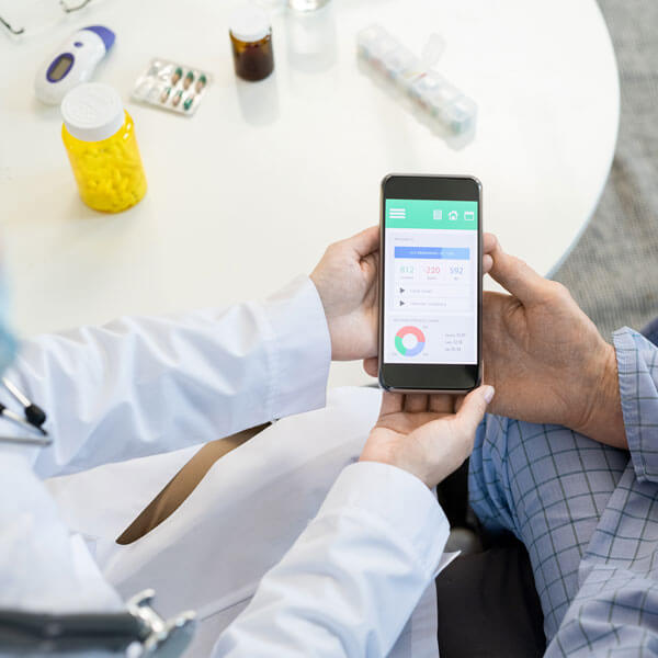 doctor and patient looking at health app