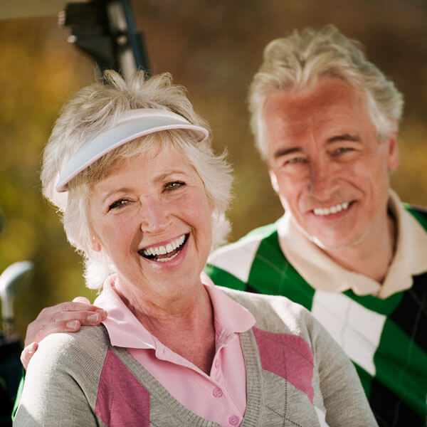 senior couple golfing